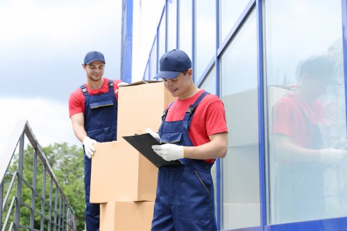 Removal team handling household moving boxes in Harrow