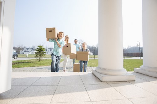 Movers carrying boxes and furniture during a local relocation in Harrow