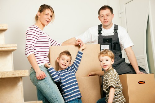 Removal team carrying furniture from a flat in Harrow