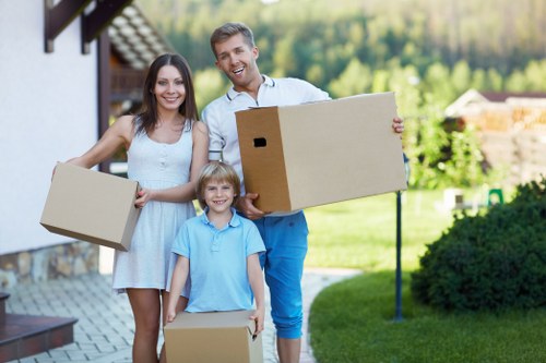 Trained movers handling furniture carefully in a Harrow property