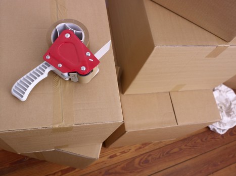 Removalists carefully carrying furniture from a flat in Harrow