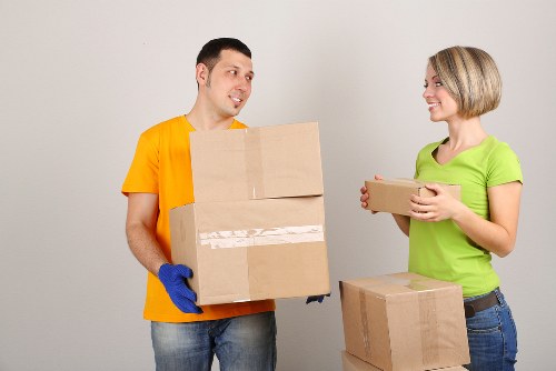 Careful loading of household items during a flat relocation in Harrow